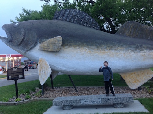Griffin posing with an oversized walleye statue in Baudette, MN